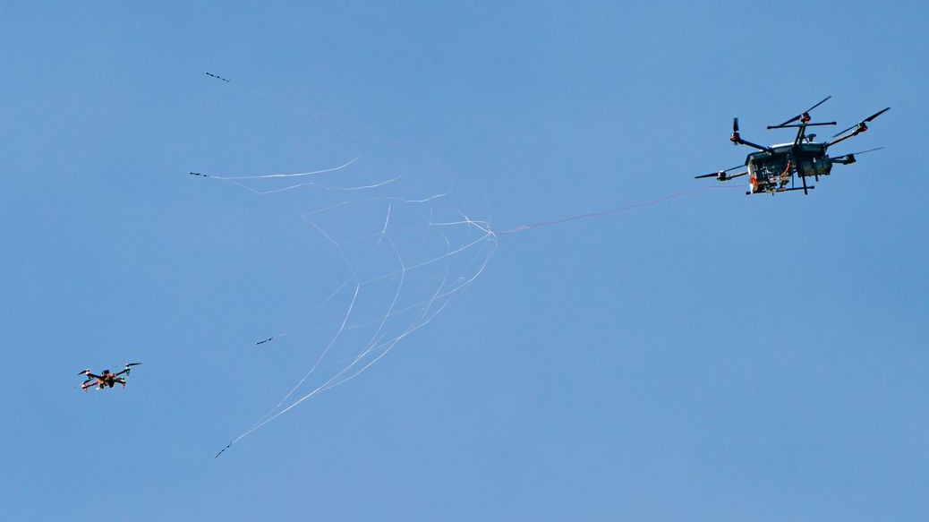 Fortem product photography shows a DroneHunter net interception. Context imagery from the company's product page; it is not footage of the October partnership or proof of FireThorn performance.