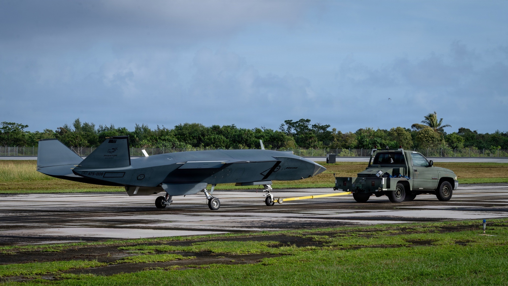 MQ-28 Ghost Bat on its landing gear being towed across an airfield